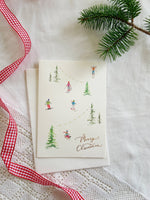 Skiers in the Snow Gold-Foiled Luxury Christmas Card