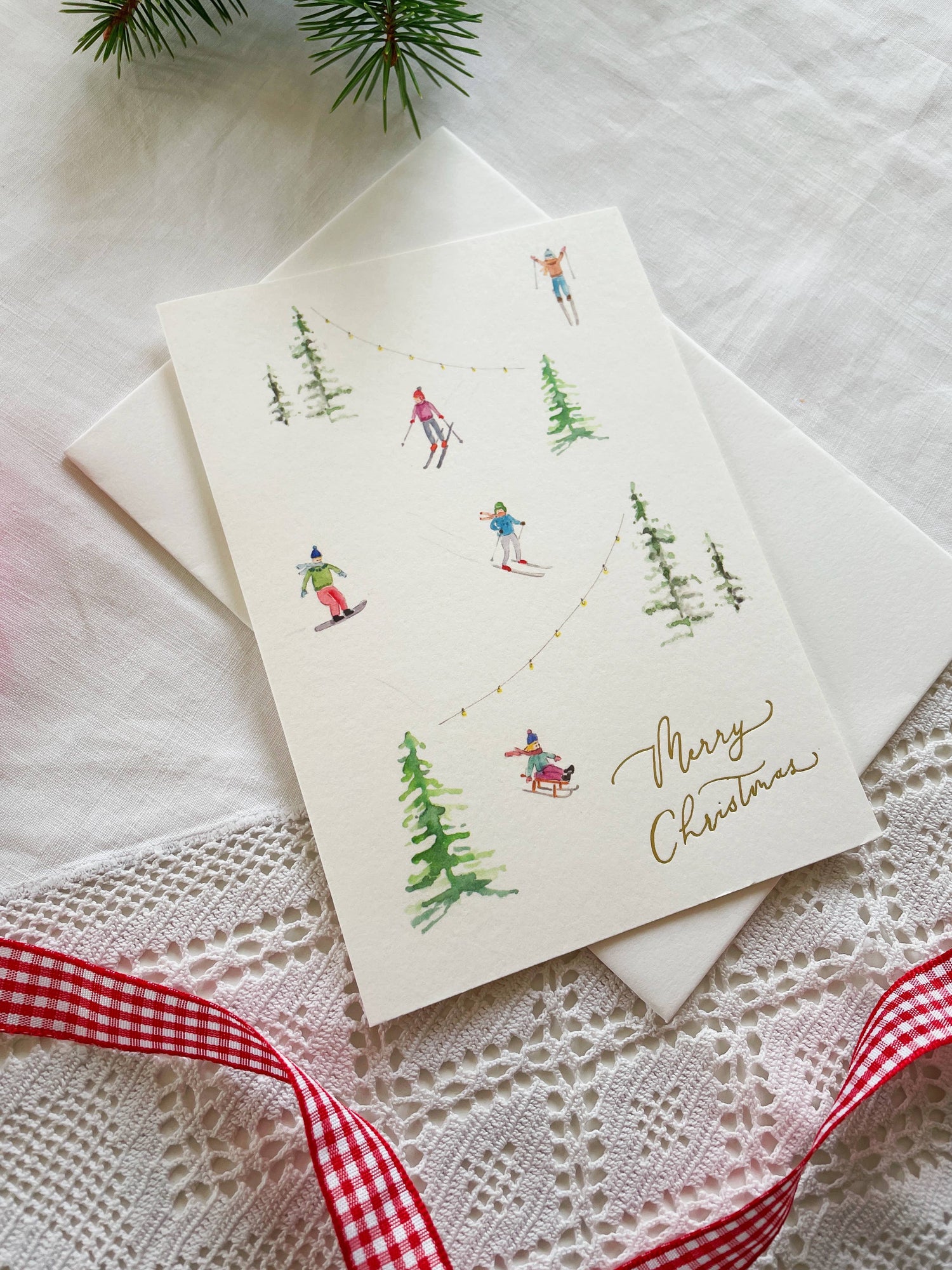 Skiers in the Snow Gold-Foiled Luxury Christmas Card