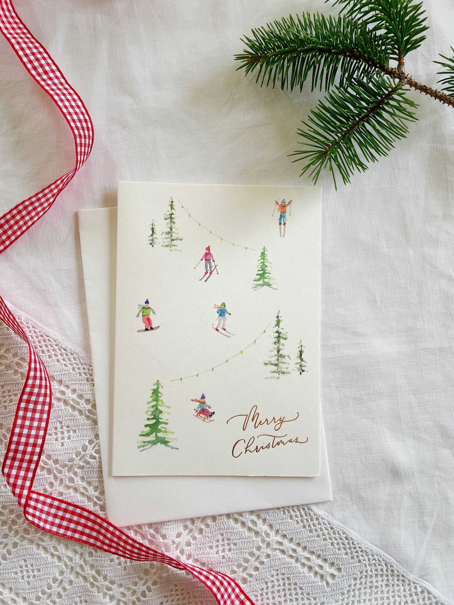 Skiers in the Snow Gold-Foiled Luxury Christmas Card